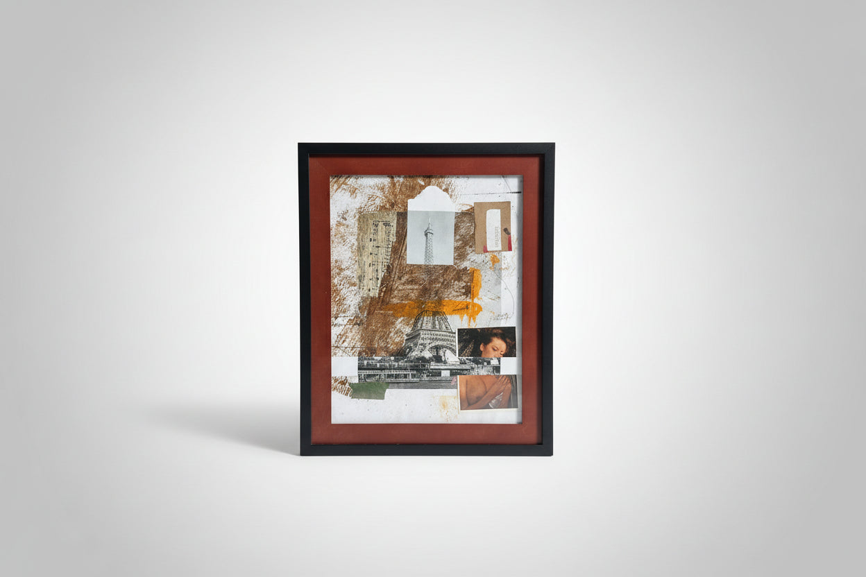Framed collage leaning against a brick wall