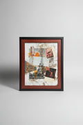 Framed collage art piece on a sidewalk with a brick building in the background