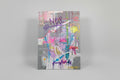 Colorful abstract drawing on a piece of canvas with text and graphics.