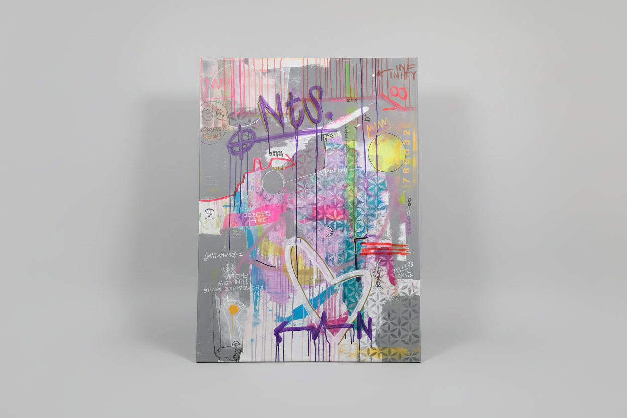 Colorful abstract drawing on a piece of canvas with text and graphics.